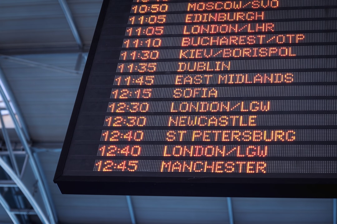 Nomad Protocol | Practical Solo Travel Traveler reviewing an airport departure board